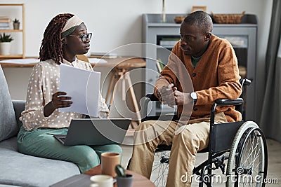 African-American Wheelchair User Talking to Business Consultant Stock Photo