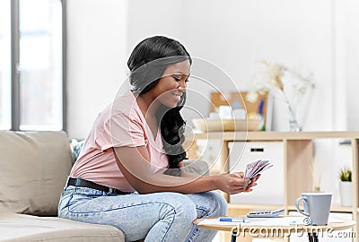 African american woman counting money at home Stock Photo