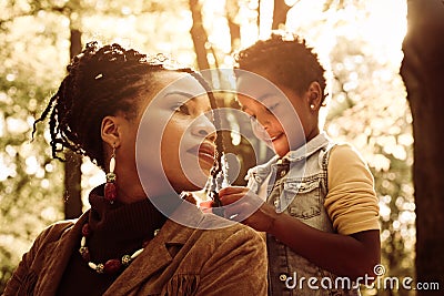 African American woman with daughter in park. Stock Photo