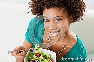 African American Woman Eating Salad Stock Photo