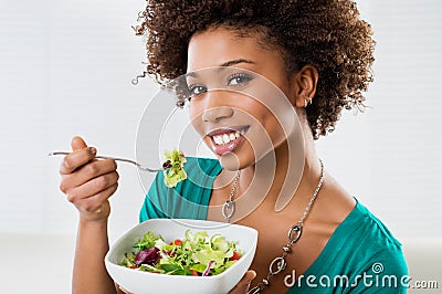 African American Woman Eating Salad Stock Photo