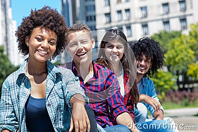 African american woman with group of multicultural young adults in a row Stock Photo