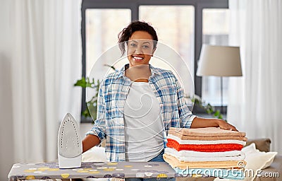 African american woman with ironed linen at home Stock Photo