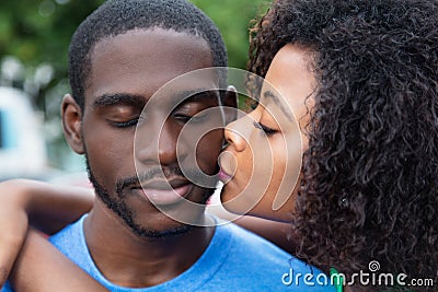 African american woman kissing boyfriend Stock Photo