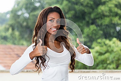 African american woman with long hair showing both thumbs up Stock Photo