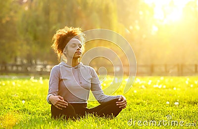 African american woman meditating in nature Stock Photo