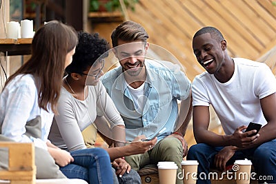 African American woman show to laughing friends funny news Stock Photo