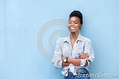 African american woman smiling with arms crossed on blue background Stock Photo