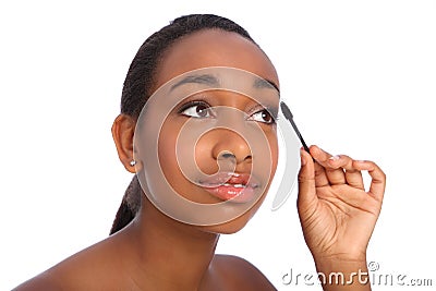 African American woman using mascara brush Stock Photo