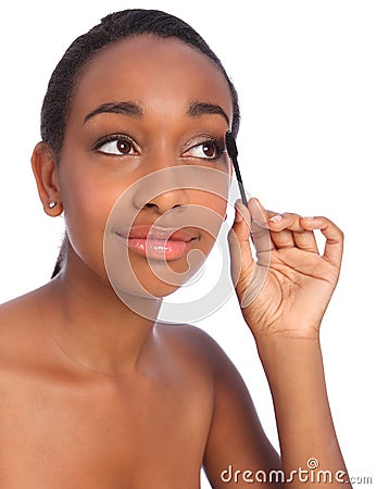 African American woman using mascara brush Stock Photo