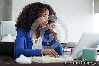 African American Woman Working At Home Coughing And Sneezing Stock Photo