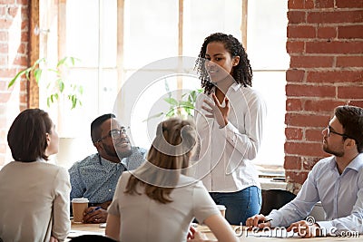 African American woman standing and talking at briefing Stock Photo