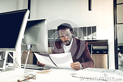 African-American young businessman reading the financial reports Stock Photo