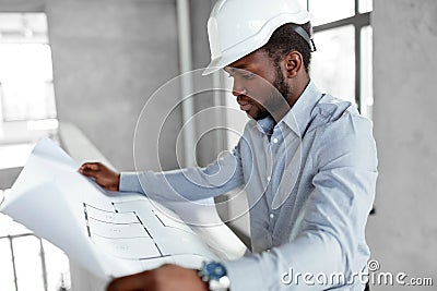 African architect in helmet with blueprint Stock Photo