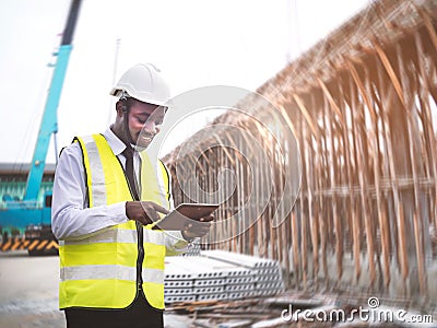 African architects engineer man with tablet work together in the inside the construction building site.Engineering concepts and Stock Photo