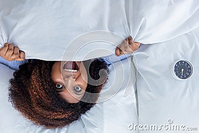 African awesome woman screaming while lying in the bed Stock Photo