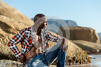 African black model with six pack in unbuttoned checkered shirt Stock Photo