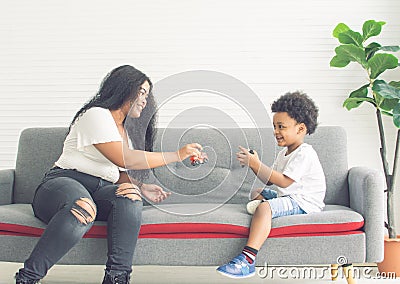 African black mother playing with her son at home Stock Photo