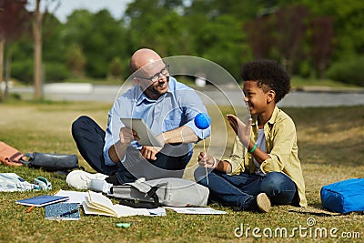 African Boy Talking to Teacher during Outdoor Lesson Stock Photo