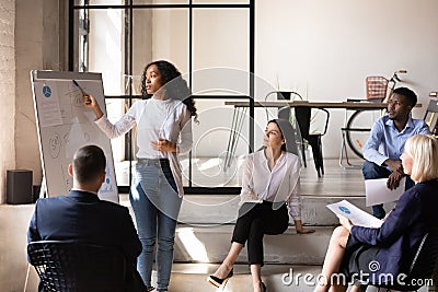 African businesswoman manager give presentation on whiteboard at office meeting Stock Photo