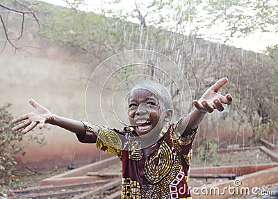 Sweet little African boy under the rain in Mali Africa Stock Photo