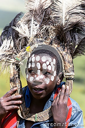 African children with ostrich feather headdress and painted markings of face Editorial Stock Photo