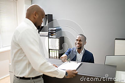 African Client At Hotel Reception Stock Photo