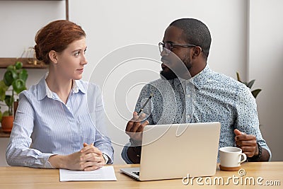 African company member training, brainstorming, sharing thoughts with female coworker Stock Photo