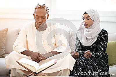 African couple at home reading quaran Stock Photo