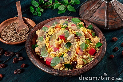 African couscous in the tagine, with spices and herbs Stock Photo