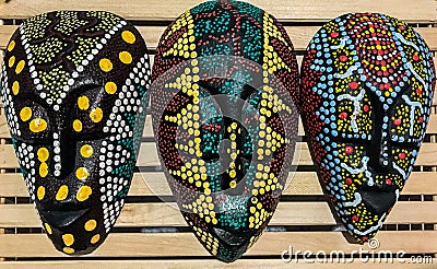 African culture tribal wooden back masks painted in colorful dots Stock Photo