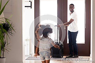 African daughter running to meet father returned from business trip Stock Photo