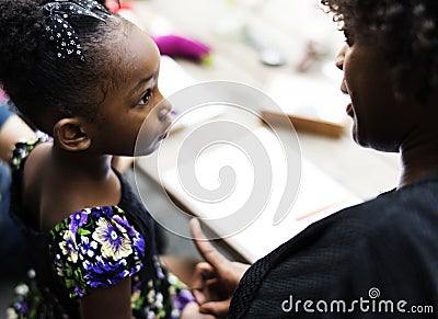 African descent girl is listening to her teacher Stock Photo