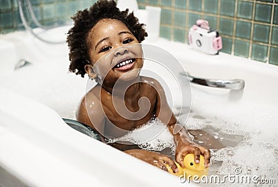 African descent kid enjoying bath tub Stock Photo