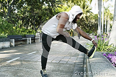 African descent man stretching at the park Stock Photo