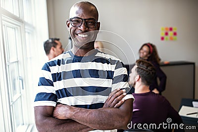 African designer smiling confidently after an office meeting Stock Photo