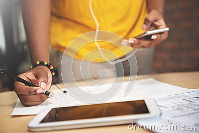 African designer in yellow shirt is working with sketching drawing. Stock Photo