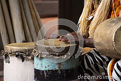 A African Drummer playing on a drum in day time. Stock Photo