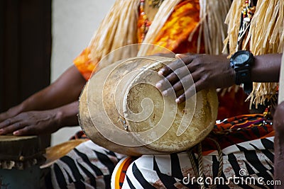 A African Drummer playing on a drum in day time. Stock Photo