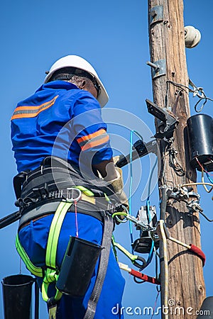African electrician on a pole Editorial Stock Photo