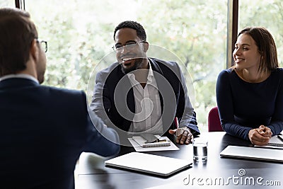 African executive manager welcoming client starting negotiations in office Stock Photo