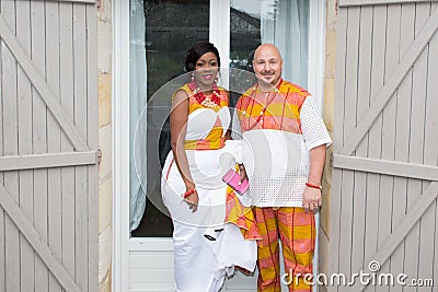 African family in bright ethnic clothes in front of house for wedding mixed race interracial american Stock Photo