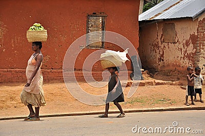 African family carrying banana basket on the head Editorial Stock Photo