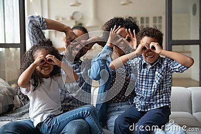 African family showing binoculars with fingers smile look at camera Stock Photo