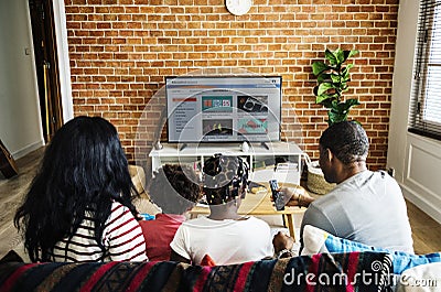 African family watching television together Stock Photo