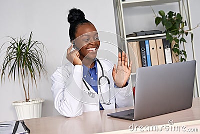 African female doctor talk to patient by telemedicine online webcam video call. Stock Photo