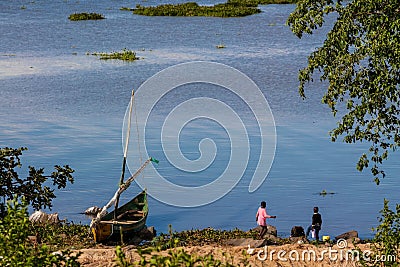 African fisherman boat and children at hte lake shore Editorial Stock Photo