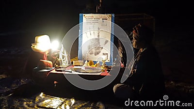 African Fortuneteller Lady Sits On The Beach Fingering Tarot Cards
