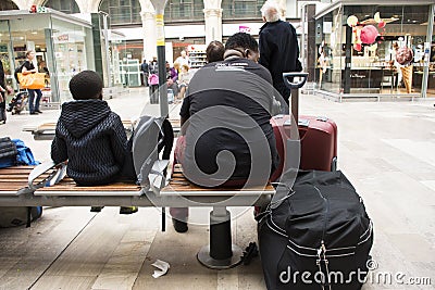 African-French people sitting and waitting train at Gare de Paris-Est Editorial Stock Photo