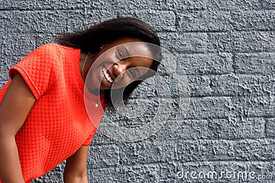 African girl bending down and laughing Stock Photo